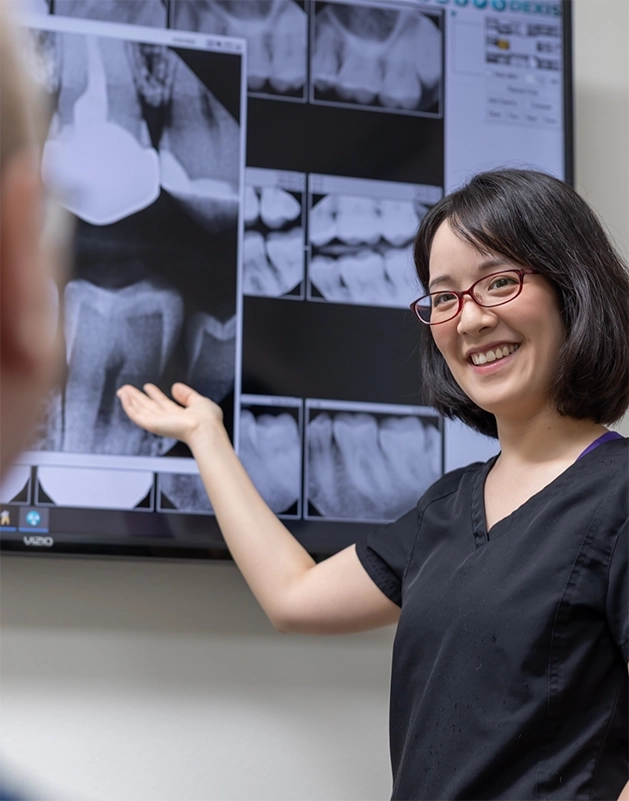 Doctor Cao showing a patient their dental x-rays