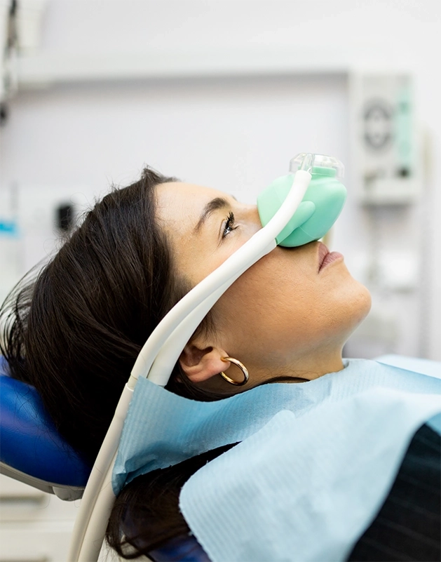 Dental patient with a nitrous oxide mask on her nose