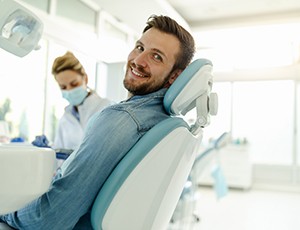 Happy dental patient looking over his shoulder