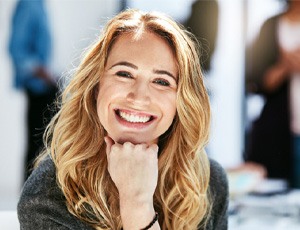 a woman smiling with dental bridges in Richardson