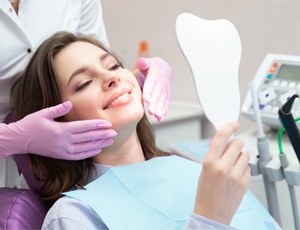 patient smiling after getting dental bridge in Richardson