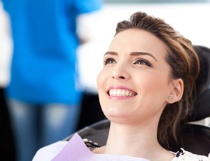 woman smiling during dental checkup and teeth cleaning