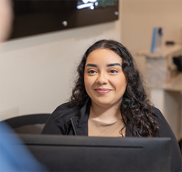 Dental team member smiling at a patient