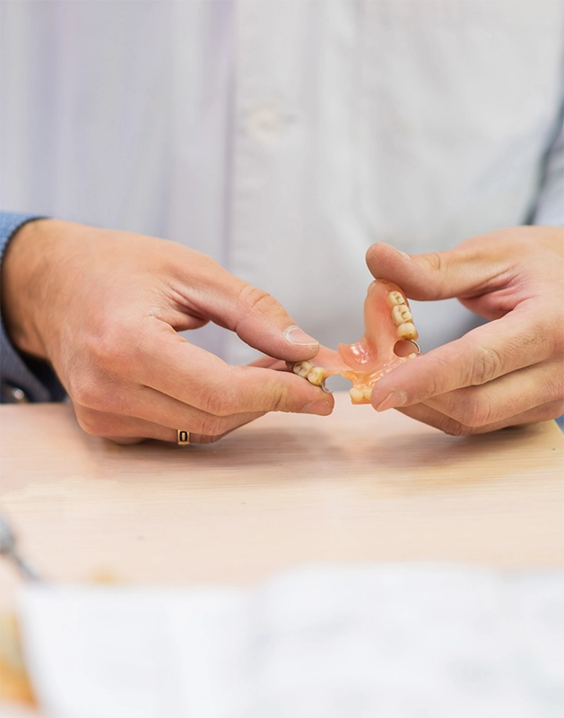 Person examining a denture