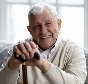 Smiling senior man holding his cane