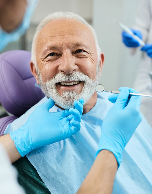 Senior man smiling at his dentist during a checkup