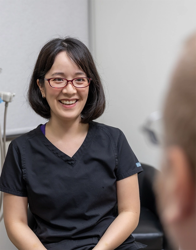 Doctor Cao talking with a dental patient