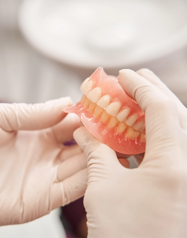 Dentist holding a set of full dentures