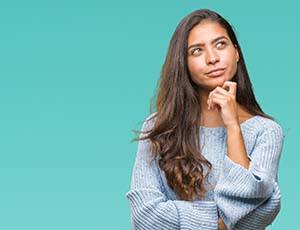 Woman thinking and looking up inquisitively