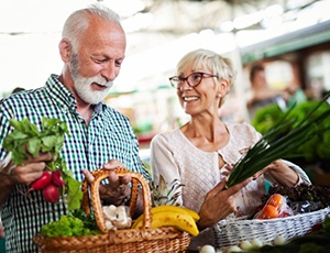 older couple buying fresh fruits and vegetables 