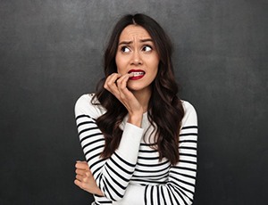 worried woman biting her nails 