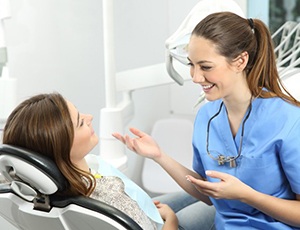 woman talking to her dental hygienist at a checkup 