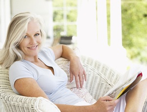 Woman with implant dentures smiling