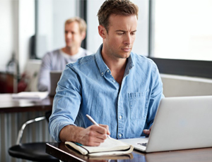 Man reviewing dental insurance on laptop