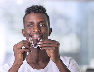 Person holding Invisalign aligner in Richardson