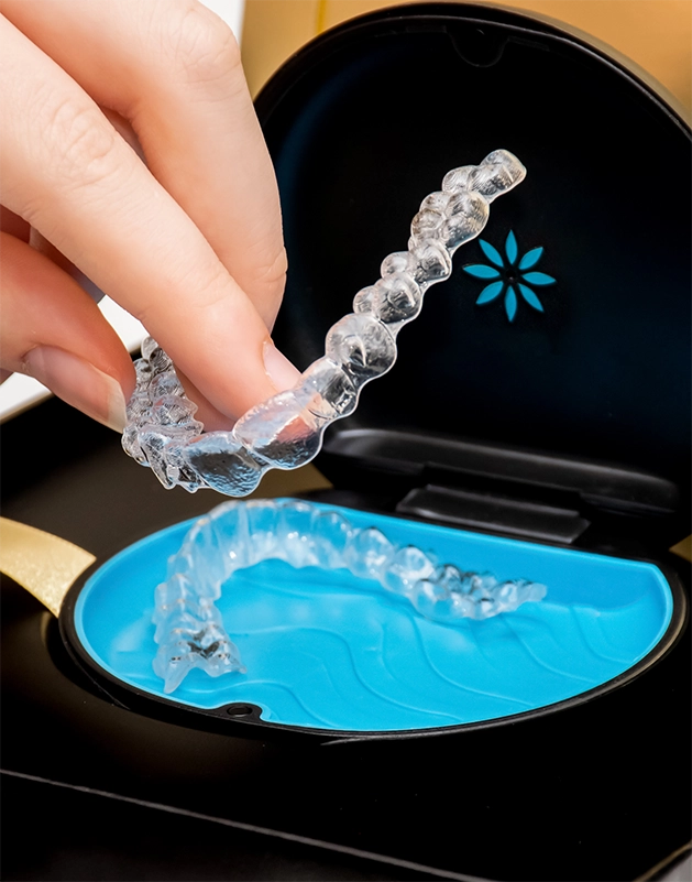 Hand putting Invisalign in its case