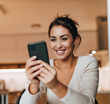 Woman smiling at her phone