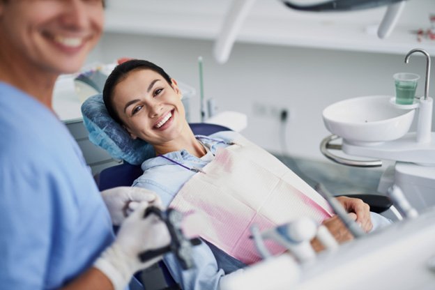 Dentist and Patient in chair smiling