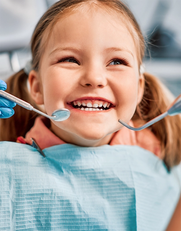 Young girl grinning during a dental checkup