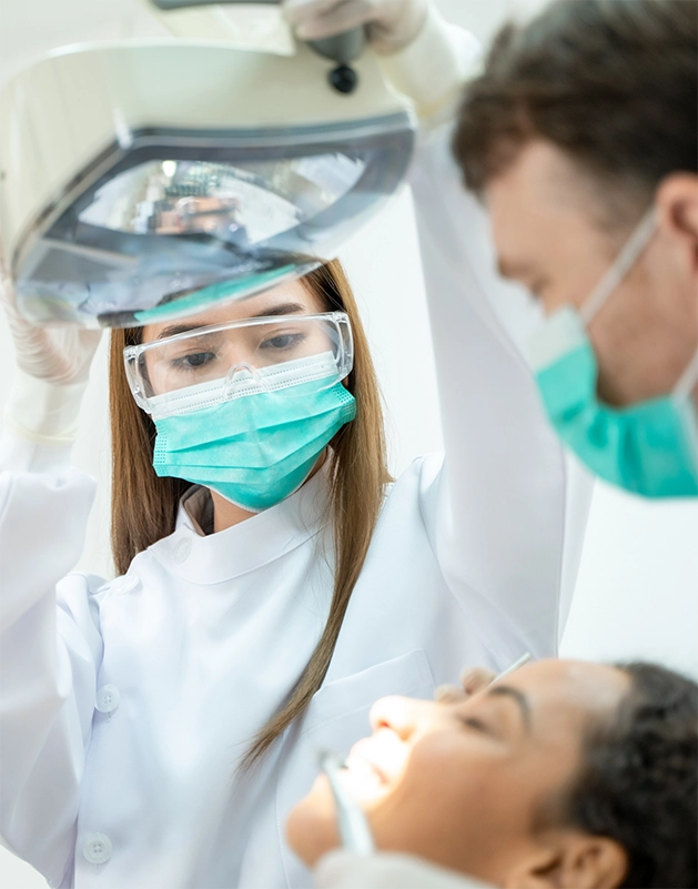 Dentist and assistant treating a patient