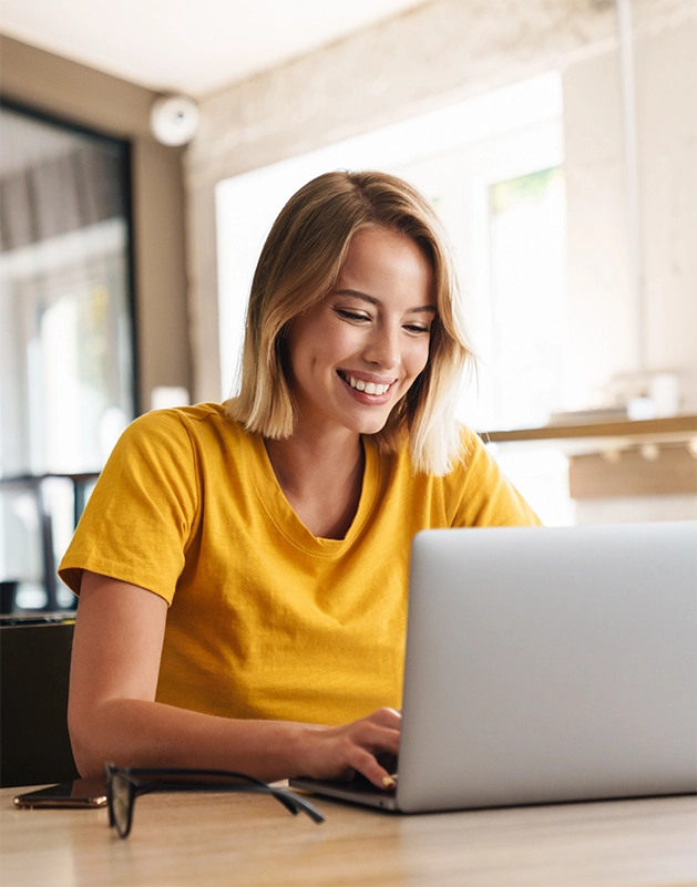 Young blonde woman using a laptop