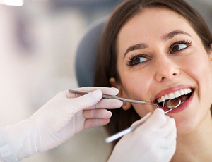 A young woman having her teeth checked by a dentist open on Saturday in Richardson