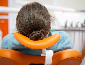 Female patient relaxing in dental chair with oral conscious sedation in Richardson, TX
