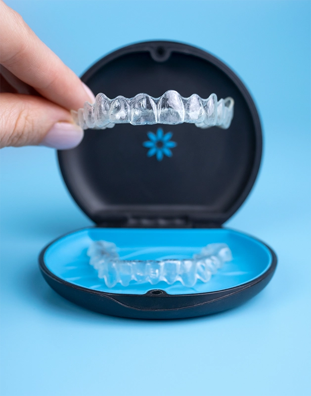 Placing an Invisalign aligner back into its storage case