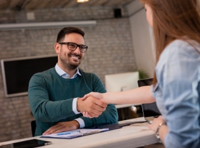 patient shaking hands with receptionist