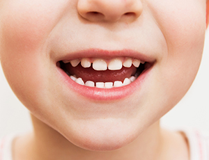 Closeup of child's healthy smile after dental sealants