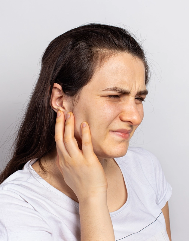 Woman holding the side of her jaw in pain