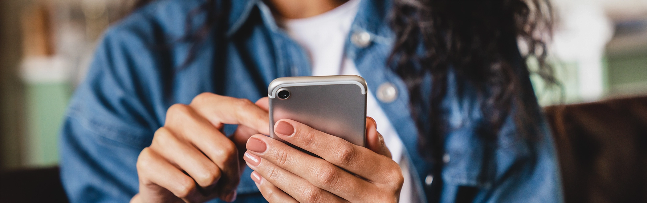Young woman clicking on her phone