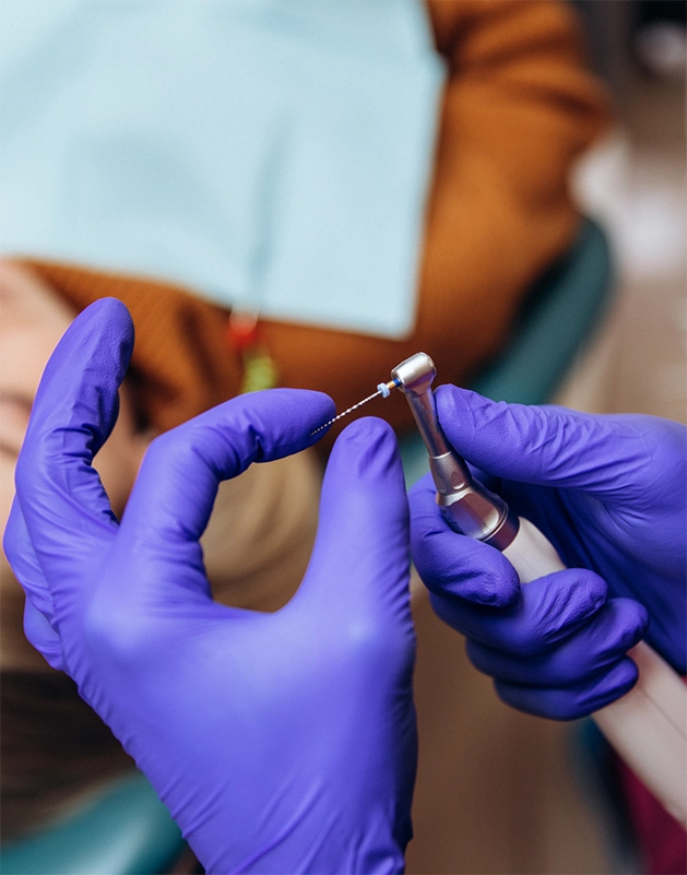 Dentist preparing a dental instrument