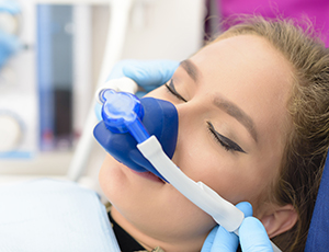 Woman in dental chair with nitrous oxide dental sedation mask