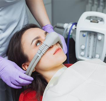 Woman in the dental chair wearing a nitrous oxide mask