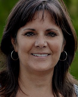 Smiling woman wearing silver hoop earrings