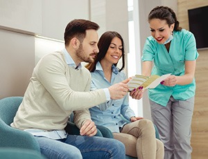 Young couple learning about options for paying for SureSmile