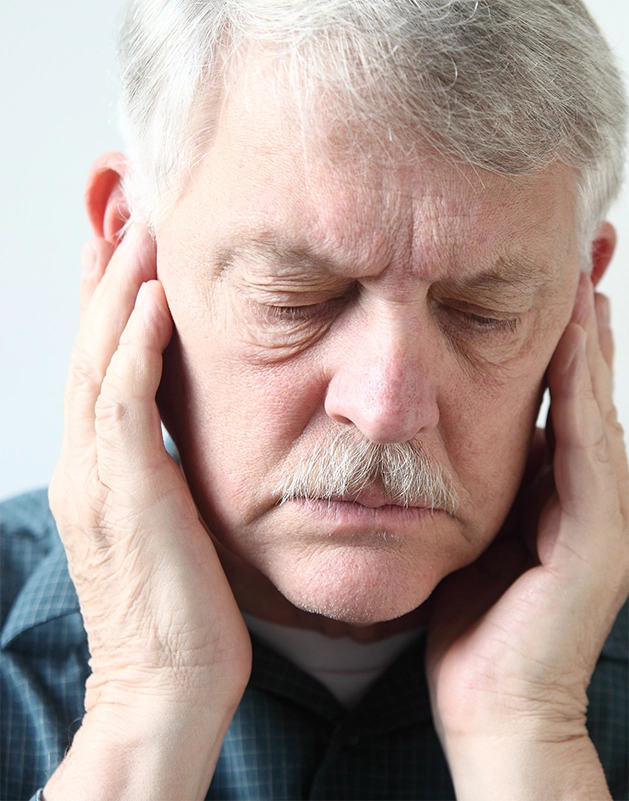 Man holding his temples in pain