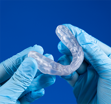 Dentist holding a clear nightguard