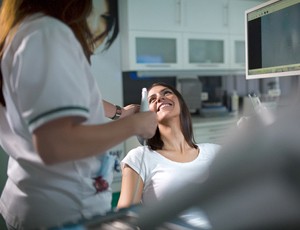 Woman smiling at her dentist in Richardson after tooth extraction