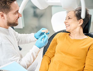 Female patient listening to dentist talk about dentures