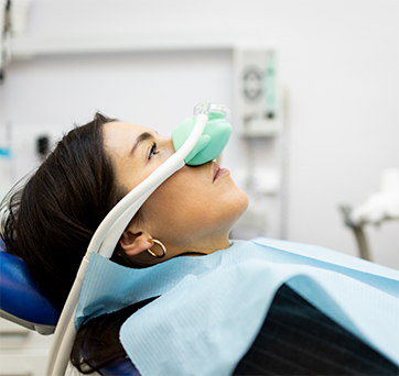 Dental patient with a nitrous oxide mask on her nose