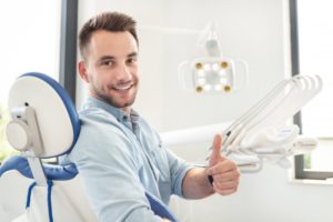 smiling man giving thumbs up at his dentist in Richardson