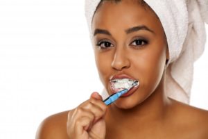 woman brushing to prevent dental emergencies in Richardson