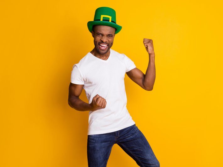 person wearing a leprechaun hat and posing