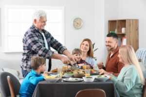 mature man celebrating thanksgiving with family  