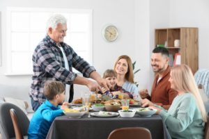 mature man celebrating thanksgiving with family