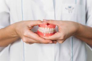 a person holding dentures