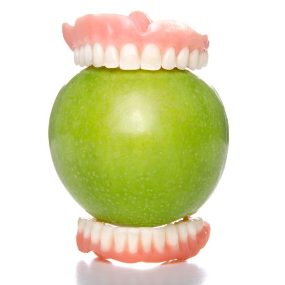 Dentures on an apple