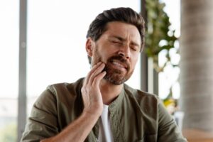 Man experiencing tooth sensitivity